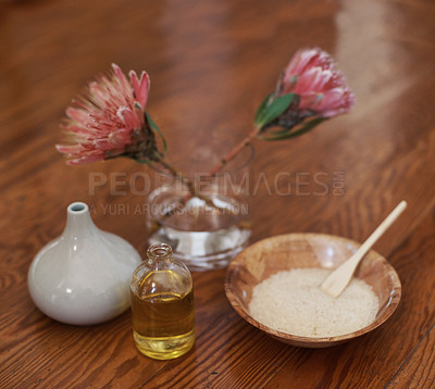 Buy stock photo Hotel, aromatherapy or spa with flowers, oil for zen, calm or peace to relax for health or natural healing. Protea plant, wellness or salt for wellbeing, holistic massage or hospitality background