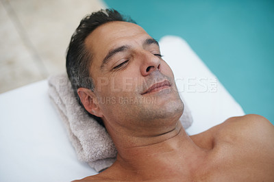 Buy stock photo Spa, man and relax for massage on table at poolside, calm and care for body in holiday. Vacation, outdoor and male person on getaway for weekend and hotel or lodge with treatment for skincare