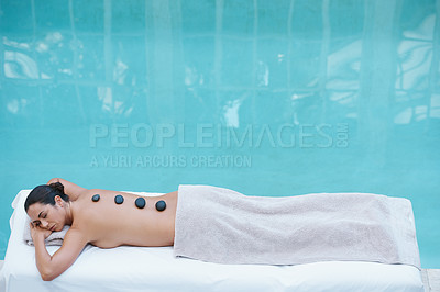 Buy stock photo Spa, hot stone massage and woman at pool at hotel for health, zen wellness and luxury holistic treatment. Self care, relax or girl on table for body therapy, comfort and calm pamper service in mockup