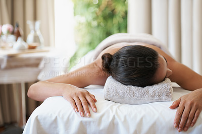 Buy stock photo Relax, peace and woman at spa for skincare, massage and calm at luxury resort. Beauty, therapy and person at salon for body treatment, health and resting at table for service to pamper for wellness