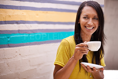 Buy stock photo Woman, drinking coffee and smile outdoors, relax and laughing for humor or comedy by wall background. Female person, happy and hot beverage for positive attitude, comic and cup for tea or confidence