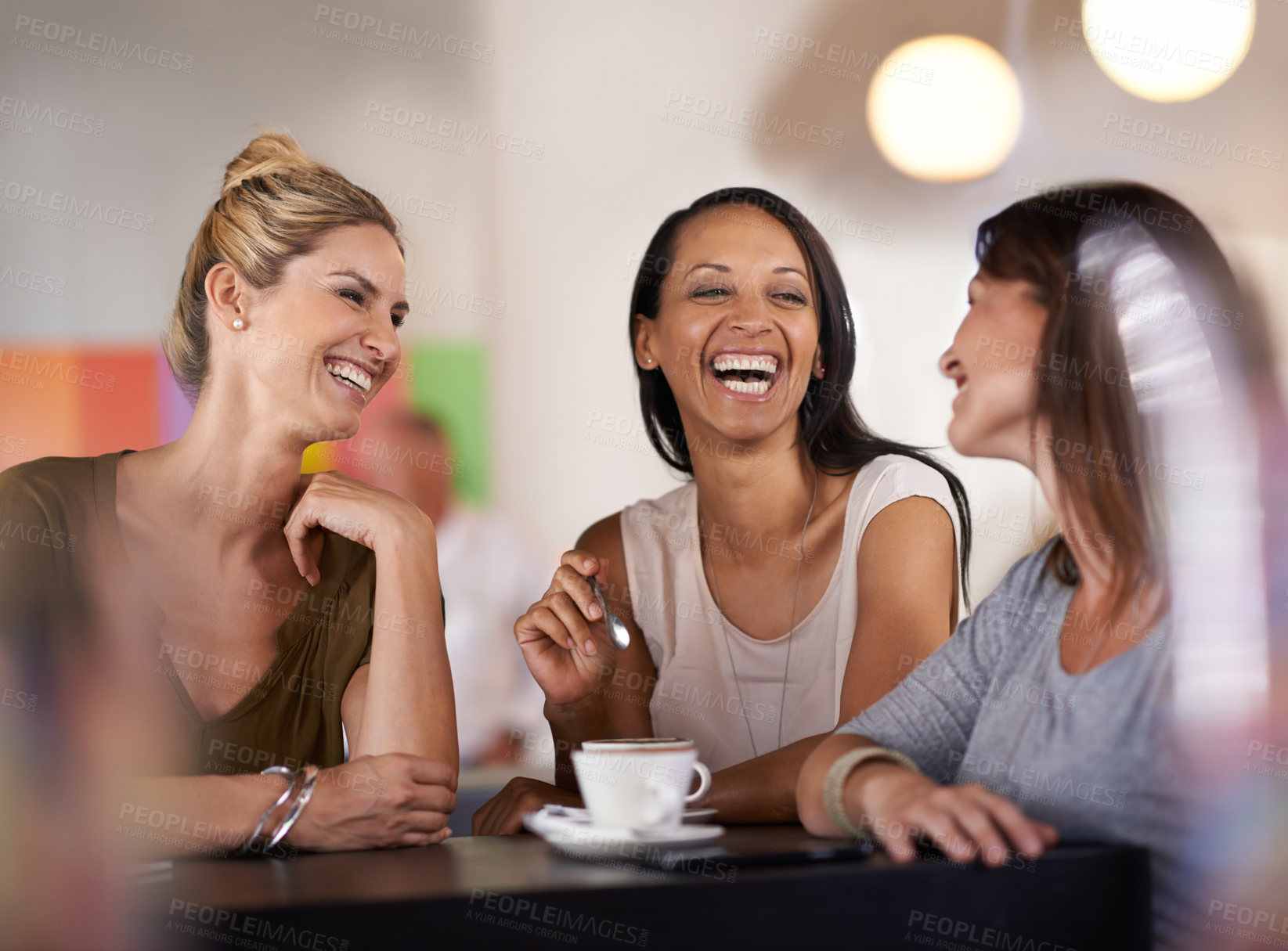 Buy stock photo Shot of three women enjoying a conversation in a restaurant