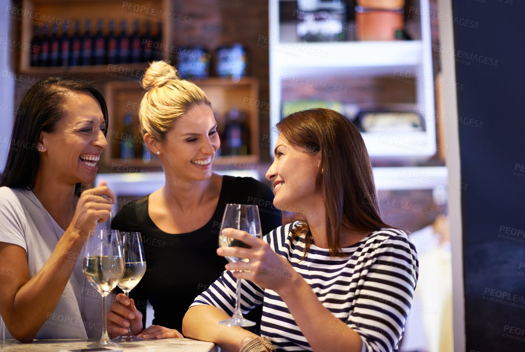 Buy stock photo Cropped shot of three women enjoying a glass of white wine in a restaurant