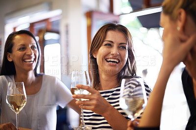 Buy stock photo Cropped shot of three women enjoying a glass of white wine