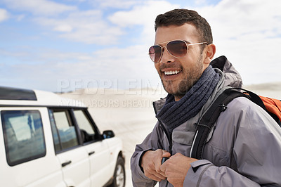 Buy stock photo Man, smile and backpack in sand dune for hike, exploration or outdoor adventure in nature. Male person, sunglasses and happiness with camping gear for journey, travel and trekking for wellness
