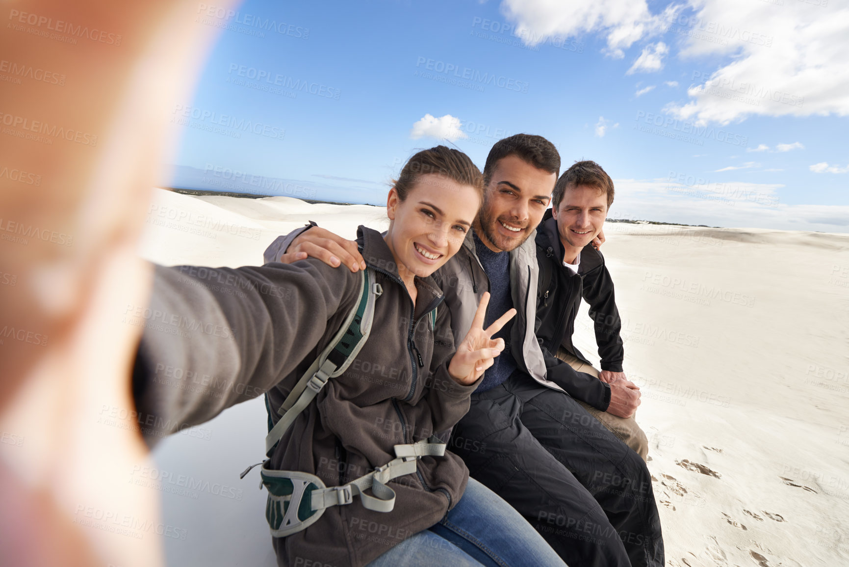 Buy stock photo Friends, desert and selfie with smile for adventure in happiness for holiday, road trip and travel together. People, memory and excited in sand dunes for vacation or break with bonding for fun