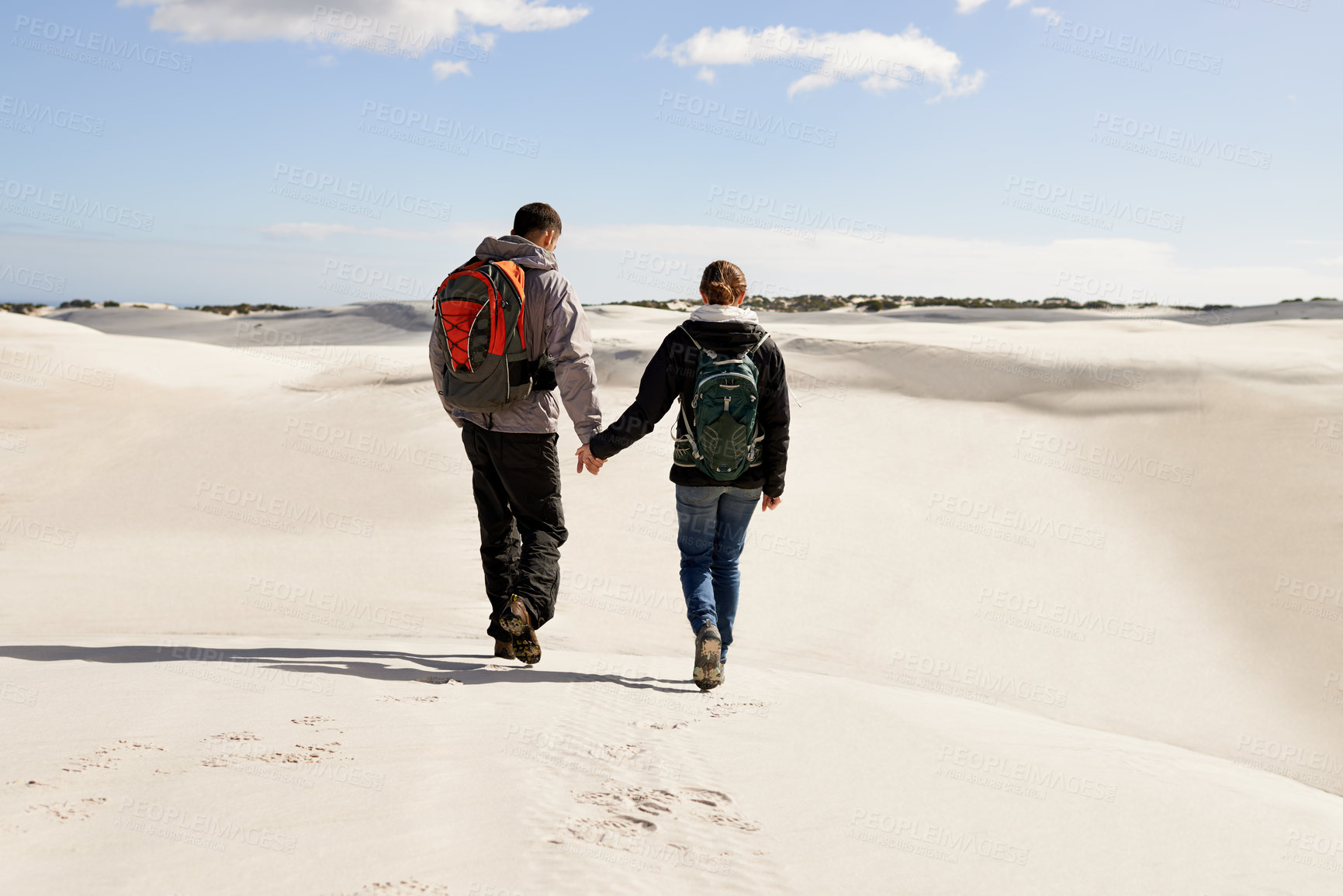 Buy stock photo Backpack, travel or couple in desert holding hands for adventure, journey or resort, location or explore. Freedom, love or back of people in Egypt for sand dunes walking, wellness or hiking in nature