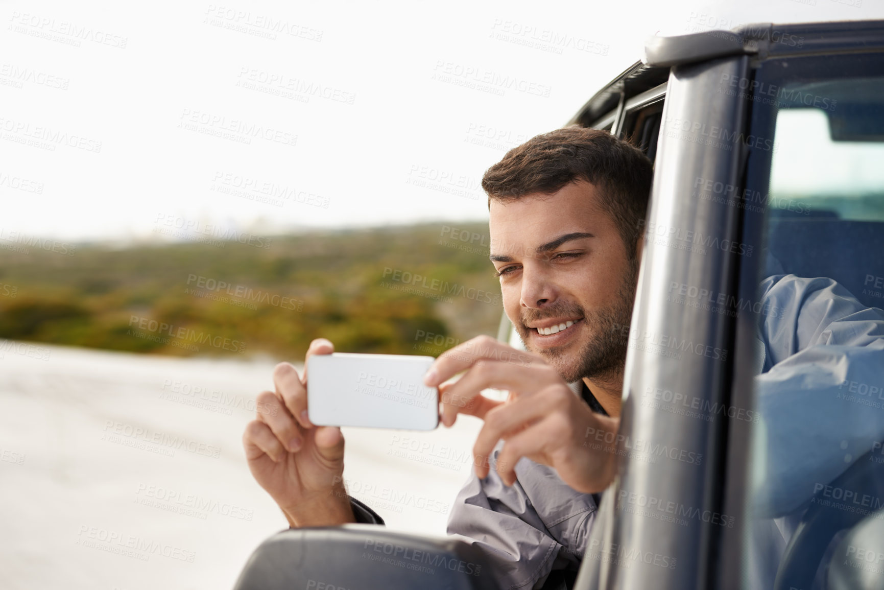 Buy stock photo Road trip, man and cellphone for photography in car, game route and sightseeing for driving for journey. Person, traveller and exploration on holiday in nature, street and leisure in vehicle in oman