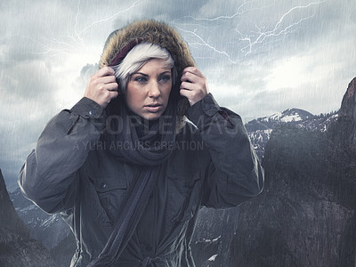 Buy stock photo Cropped shot of an attractive young woman hiking in the midst of a snow storm