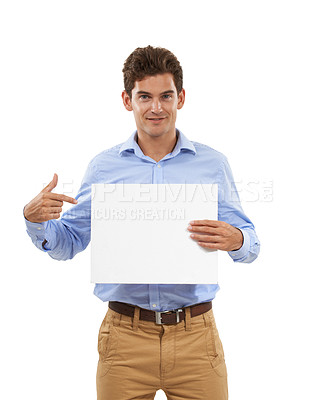 Buy stock photo Portrait, man isolated and pointing at sign with space for product placement, marketing or advertising. Mockup, blank banner and happy model showing deal announcement in studio on white background.