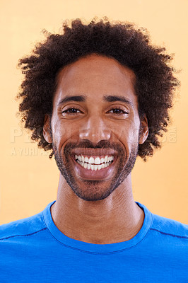 Buy stock photo A handsome young black man against a orange background