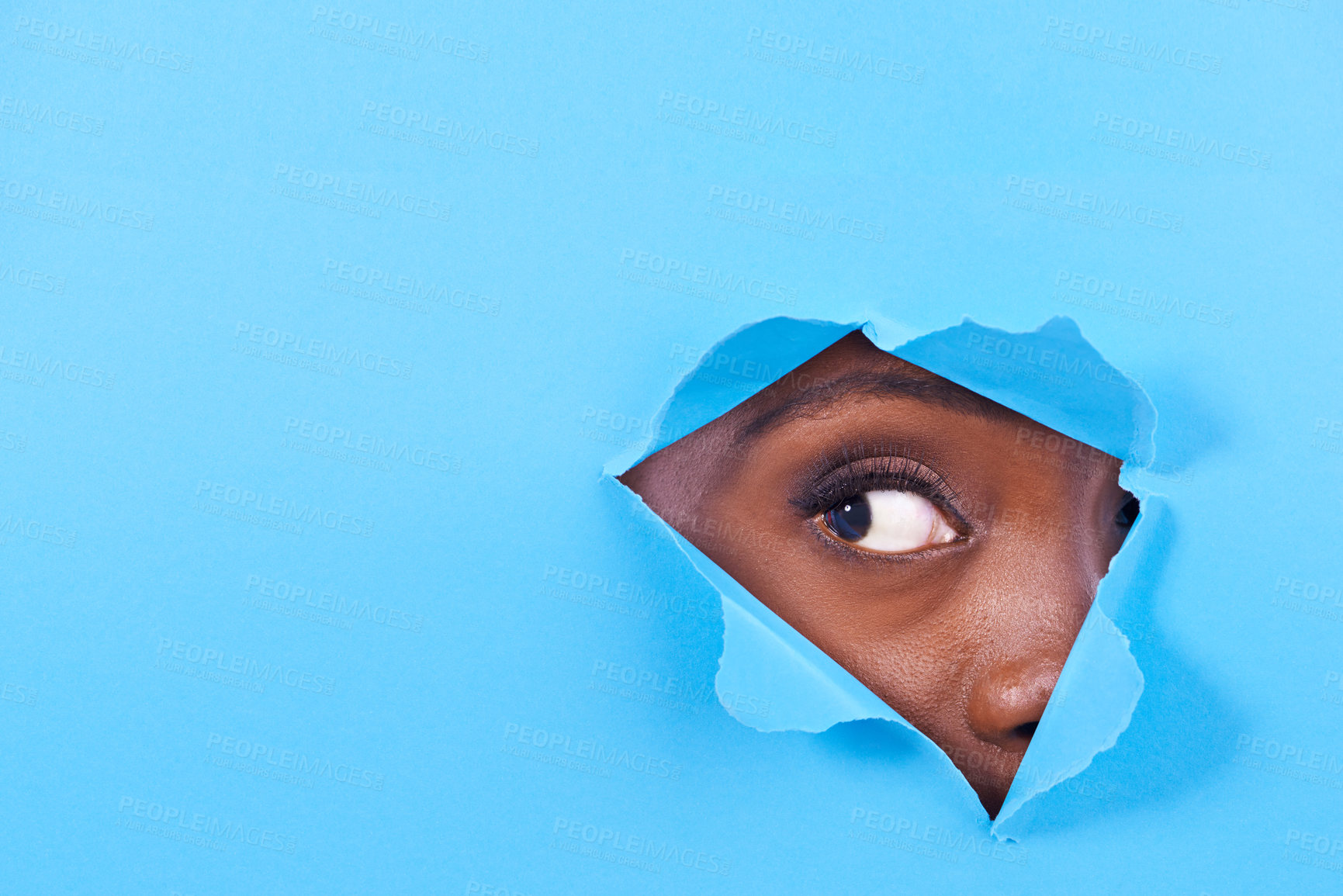 Buy stock photo Tear, hole and eye of person on blue background for vision, eyesight and looking for inspiration. Mockup space, creative aesthetic and isolated eyes in studio for curiosity, wondering or perception