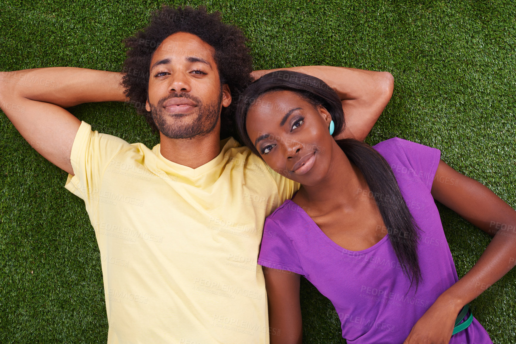 Buy stock photo Couple, portrait and top view with relax on grass for bonding, support and outdoor date in garden of home. African woman, man and face with smile on lawn for weekend break at park in nature with love