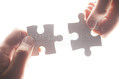 Buy stock photo Puzzle, synergy and solution with hands of person on white background for achievement, goal and development. Mission, game and cooperation with jigsaw pieces for support, success and integration