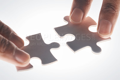 Buy stock photo Hands, puzzle and strategy in closeup for problem solving, mindset or connection with glow by white background. Games, jigsaw and link for innovation, synergy and solution with people, team or help