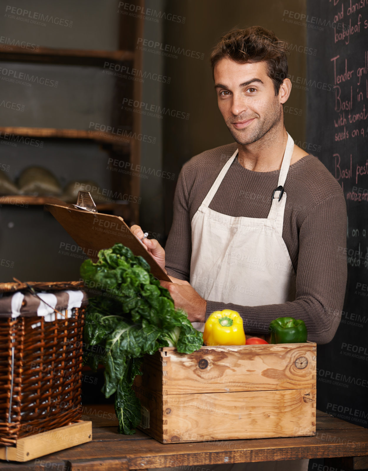 Buy stock photo Chef, clipboard and portrait of man in restaurant with vegetables for vegetarian or vegan ingredients. Happy, male cook with checklist and food from Norway for cooking in kitchen or small business.