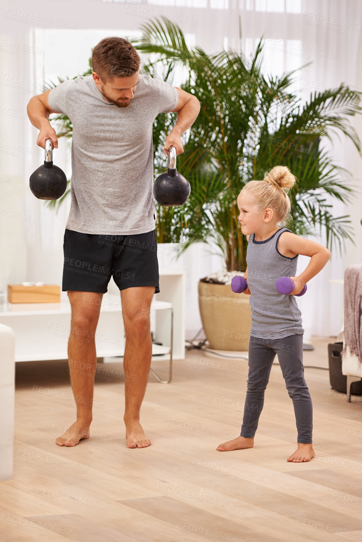 Buy stock photo Man, girl child and weightlifting for fitness, father and daughter spending time together for love in living room. Dumbbells, kettlebell and muscle training with exercise and bonding at family home