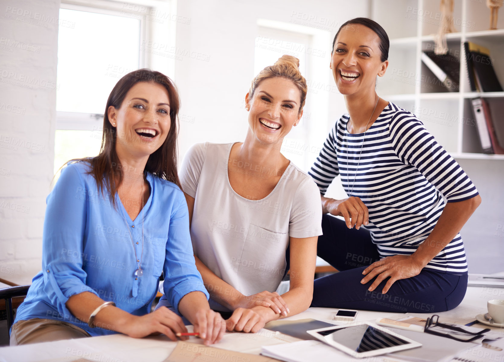 Buy stock photo Three confident young businesswomen smiling at the camera