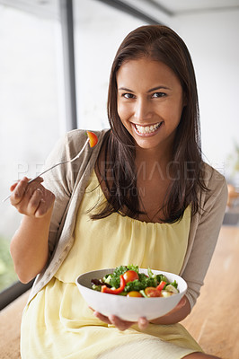 Buy stock photo A lovely young woman enjoying a healthy salad