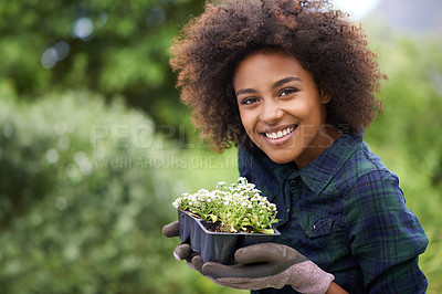 Buy stock photo Black woman is gardening, plant and smile in portrait, botany mockup and environment with young gardener and flowers. Happy female person is outdoor with green fingers, growth and plants in garden 