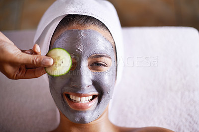 Buy stock photo Woman, smile and facial in spa for skincare, clay mask and cosmetic treatment for break or peace. Young person with cucumber on eye and product for peel for natural or holistic therapy for wellness
