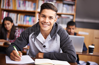 Buy stock photo Education, writing and happy with portrait of man in library for study, research or classroom quiz. Focus, learning and notebook with male student at university for knowledge, scholarship and project