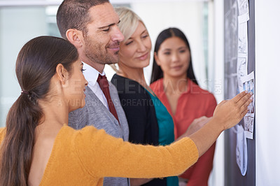 Buy stock photo Creative people, chalkboard and storyboard with team for planning, development or meeting at office. Group of employees in brainstorming or discussion for project, production or startup at workplace
