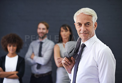 Buy stock photo Shot of a mature professional man standing in front of a group of coworkers