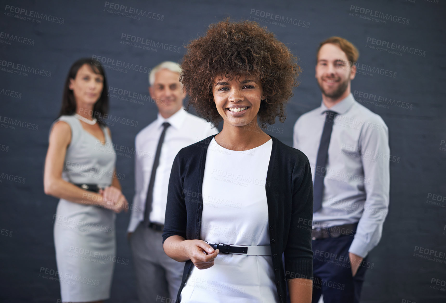 Buy stock photo Portrait, team leader and happy business woman in studio isolated on a blue background. Face, smile and group of diverse professional consultants in collaboration, cooperation and working together