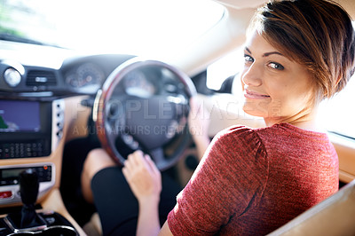 Buy stock photo Shot of a beautiful young woman driving a luxury car