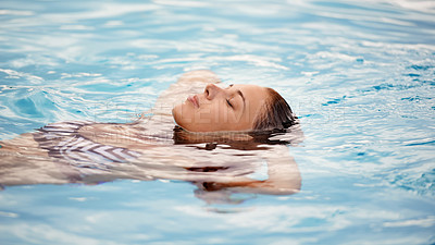 Buy stock photo Cropped shot of a beautiful young woman relaxing in a swimming pool