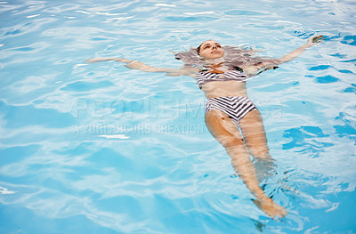Buy stock photo Bikini, swimming and woman in pool on holiday, vacation and travel to relax, calm and cool in summer. Female person, gen z girl and young lady floating with water, mockup space and outdoor in Spain