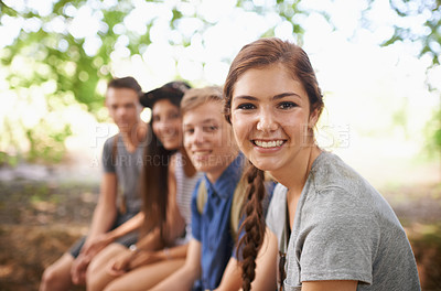 Buy stock photo Shot of a group of friends sitting together outside