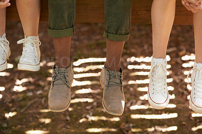 Buy stock photo Friends, shoes and legs with sneaker to relax or chill on camping and tired with break. Outdoor, closeup and diverse group to rest for leisure or summer holiday in woods,  together and fun. 