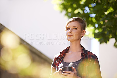 Buy stock photo A cropped shot of a beautful young woman drinking coffee in her garden