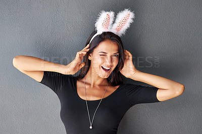 Buy stock photo Bunny ears, smile or portrait of woman with fashion isolated on wall or grey background with modern style. Funny, confident lady or female person in studio with pride, necklace and trendy clothes