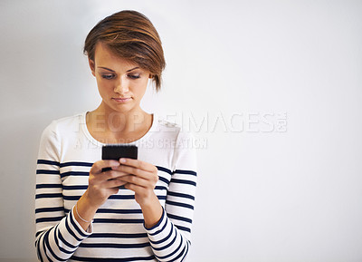 Buy stock photo Woman, studio and typing with smartphone, texting or face for social media and communication. Girl, phone and app with technology, online connection or internet message isolated on white background