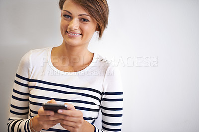 Buy stock photo Teen, studio or portrait with smartphone, smile and face for social media or communication. Girl, phone and texting with technology, online connection or internet message isolated on white background