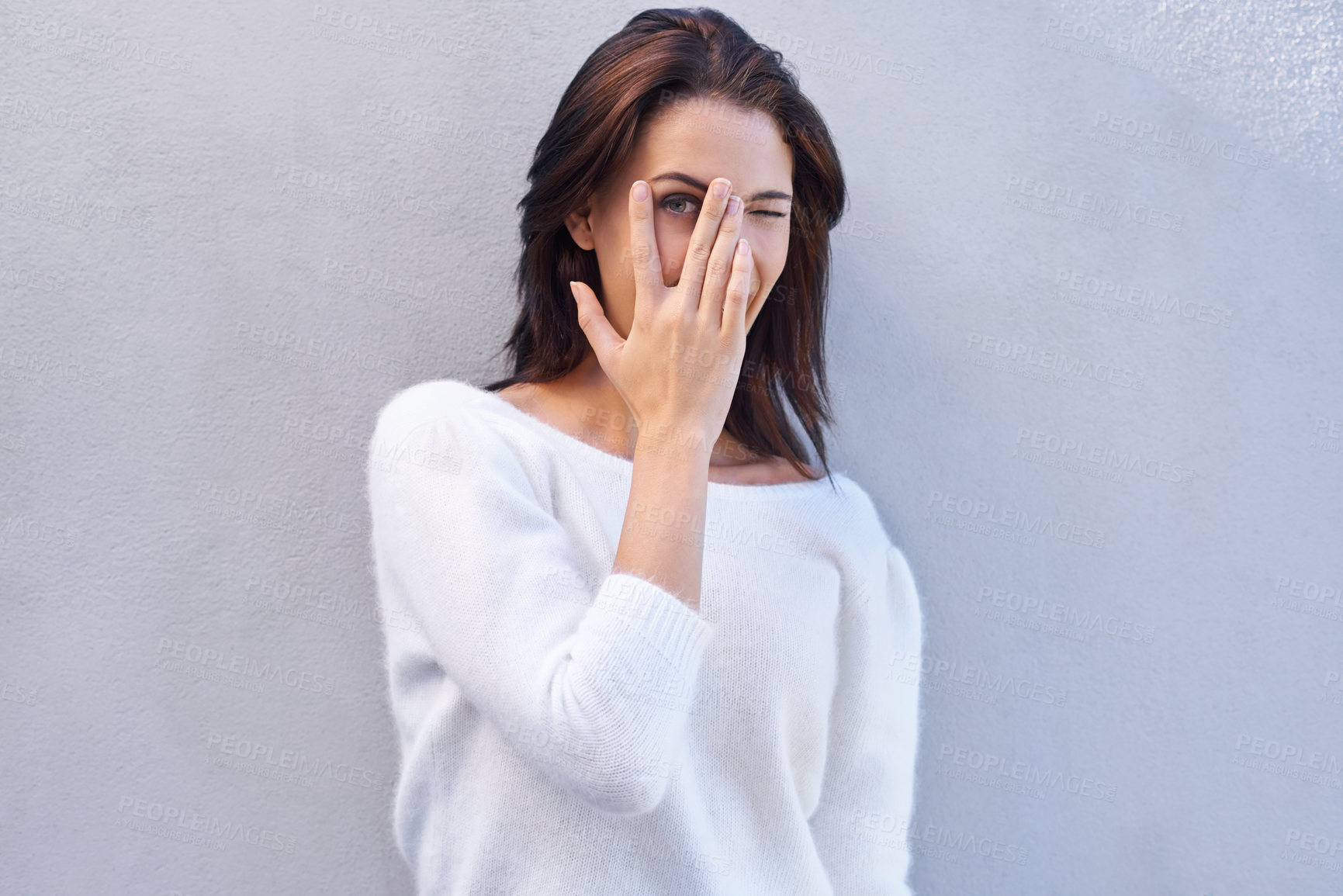 Buy stock photo Fashion, studio and woman hiding face for aesthetic of sweater, shy and casual with clothes. Blue background, female person and girl with hand to cover mouth and jersey for winter in America