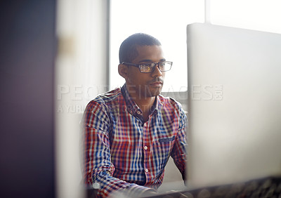 Buy stock photo Cropped shot of a focused employee working at his desk