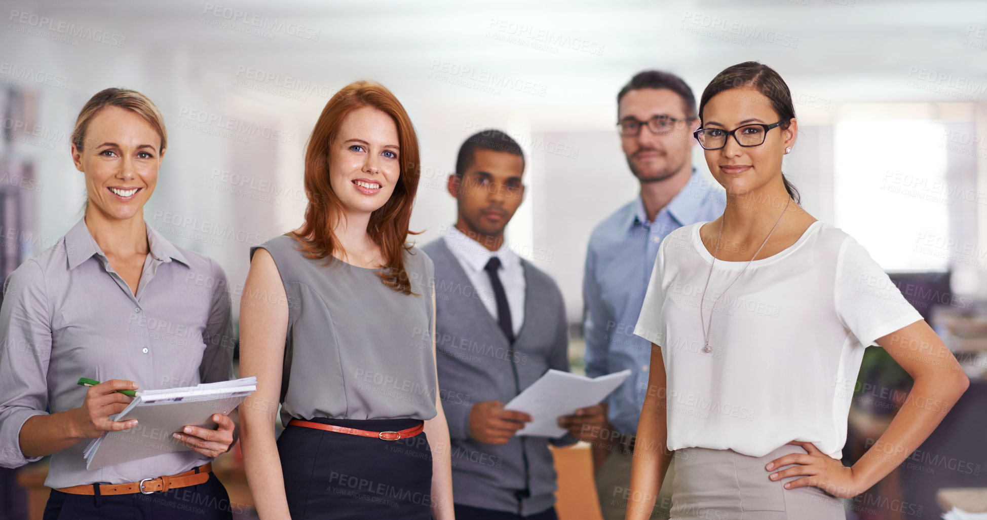 Buy stock photo Cropped portrait of a team of successful businesspeople standing in an office