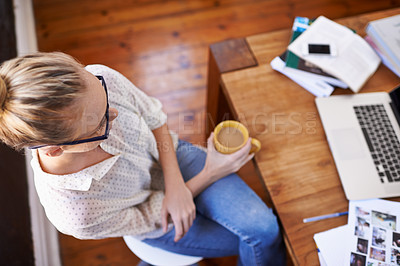 Buy stock photo A cropped high angle shot of a beautiful young woman working from home