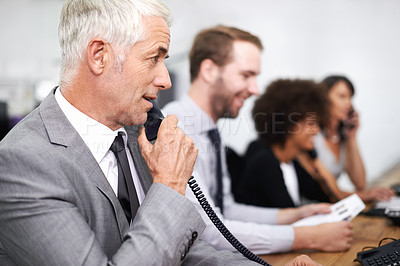 Buy stock photo Call center, man and landline in office for customer service with telemarketing, help desk and conversation. Senior, employee and face of consultant with telephone for support, telesales and advice