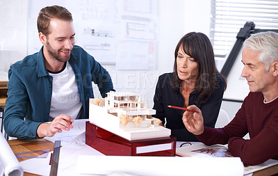 Buy stock photo Teamwork, architect and meeting with model for building, house and planning together at workspace. Engineer, group and partnership working on strategy, thinking and idea of design for construction