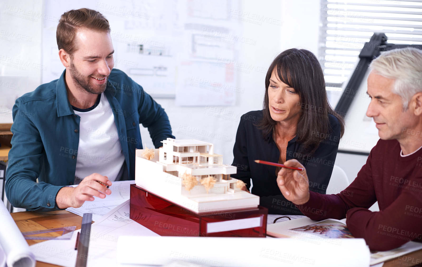 Buy stock photo Teamwork, architect and meeting with model for building, house and planning together at workspace. Engineer, group and partnership working on strategy, thinking and idea of design for construction