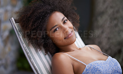 Buy stock photo Attractive female relaxing outdoors on deck chair