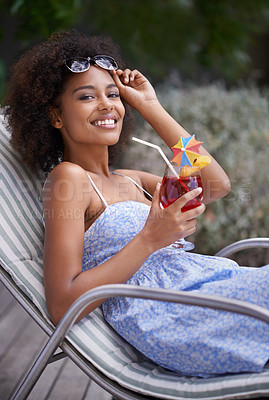 Buy stock photo African, woman and sunbathing with cocktail for summer on vacation, tropical drink and sunglasses for time fun. Happy, smile or female person laying on resort deck, comfortable or wellness or liquid