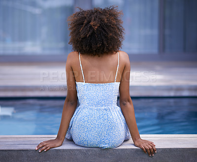 Buy stock photo Shot of the back of a woman by the pool