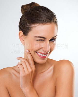Buy stock photo Studio portrait of a beautiful young woman giving you a wink