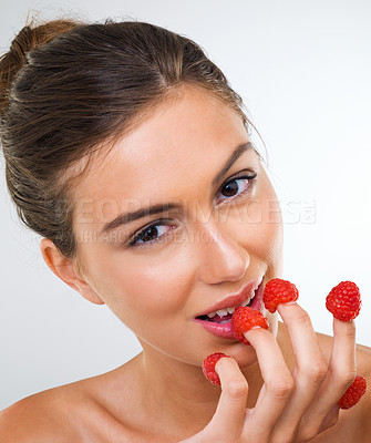 Buy stock photo Woman, portrait and raspberry for health in studio for wellness detox, healthy eating and nutrition diet. Model, person and fruit for organic cosmetics, natural beauty or skincare on white background